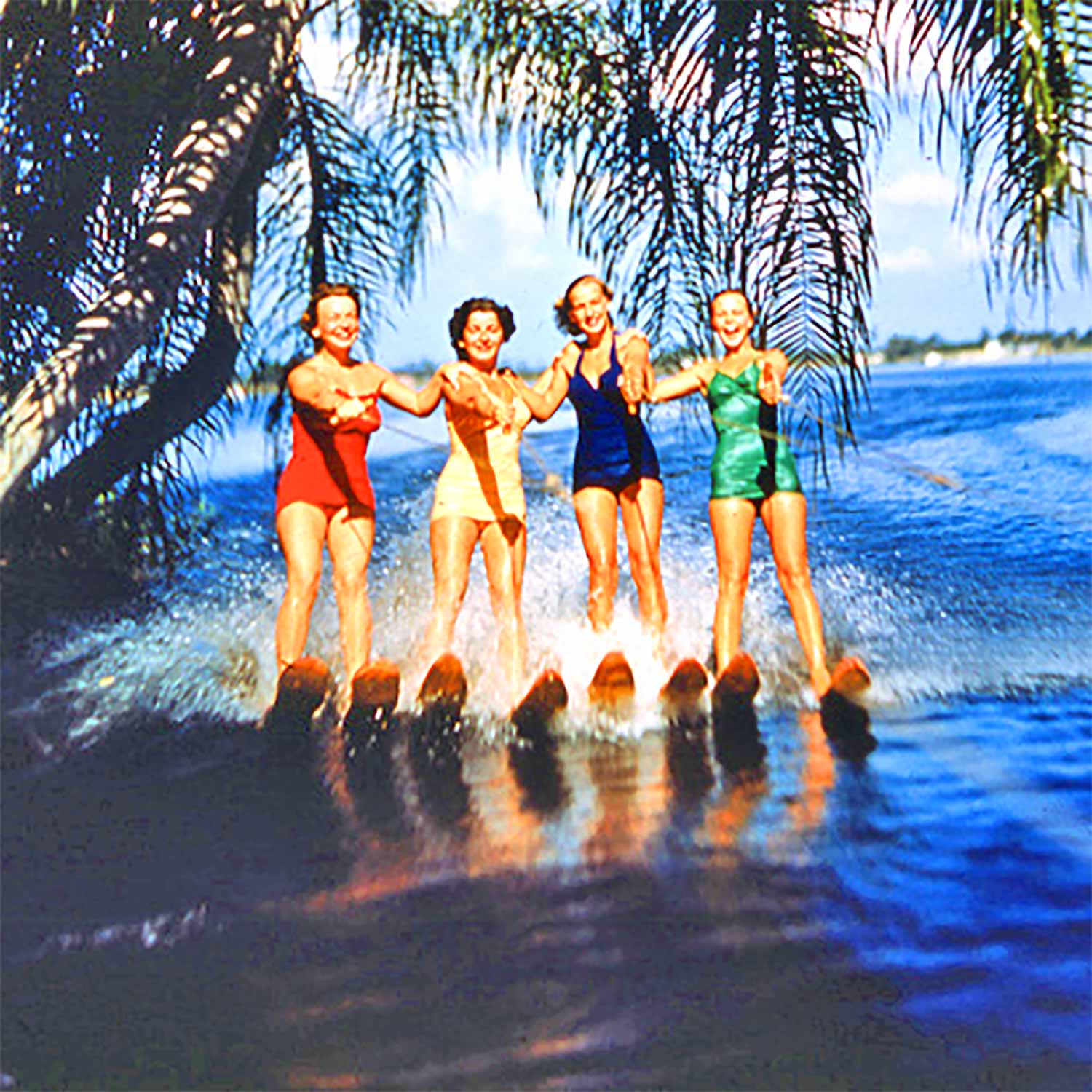 Four jubilant water-skiiers enjoy a vacation