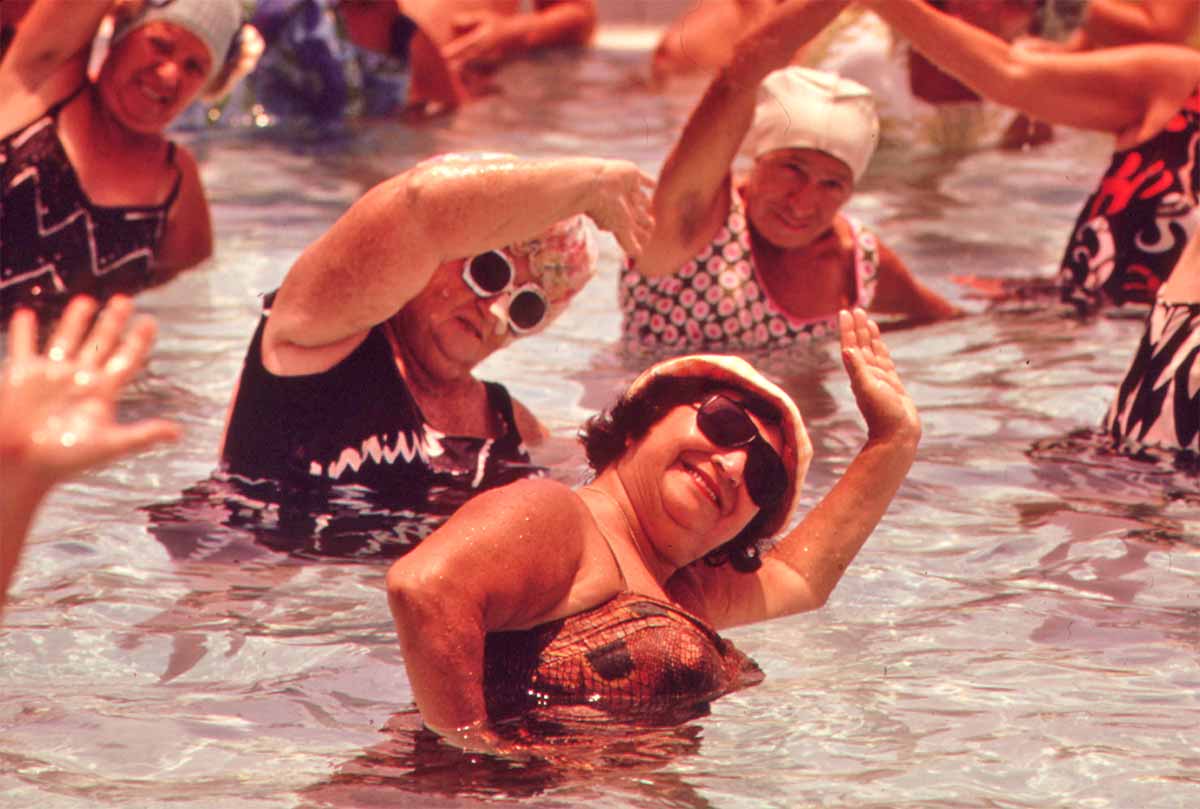 Senior citizens enjoying a swimming-pool aerobics class