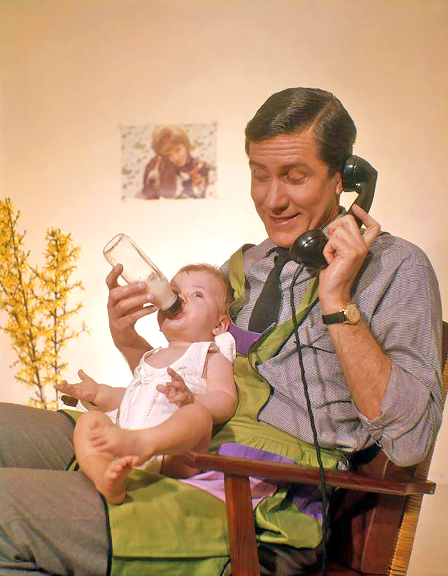 Father bottle-feeding his infant