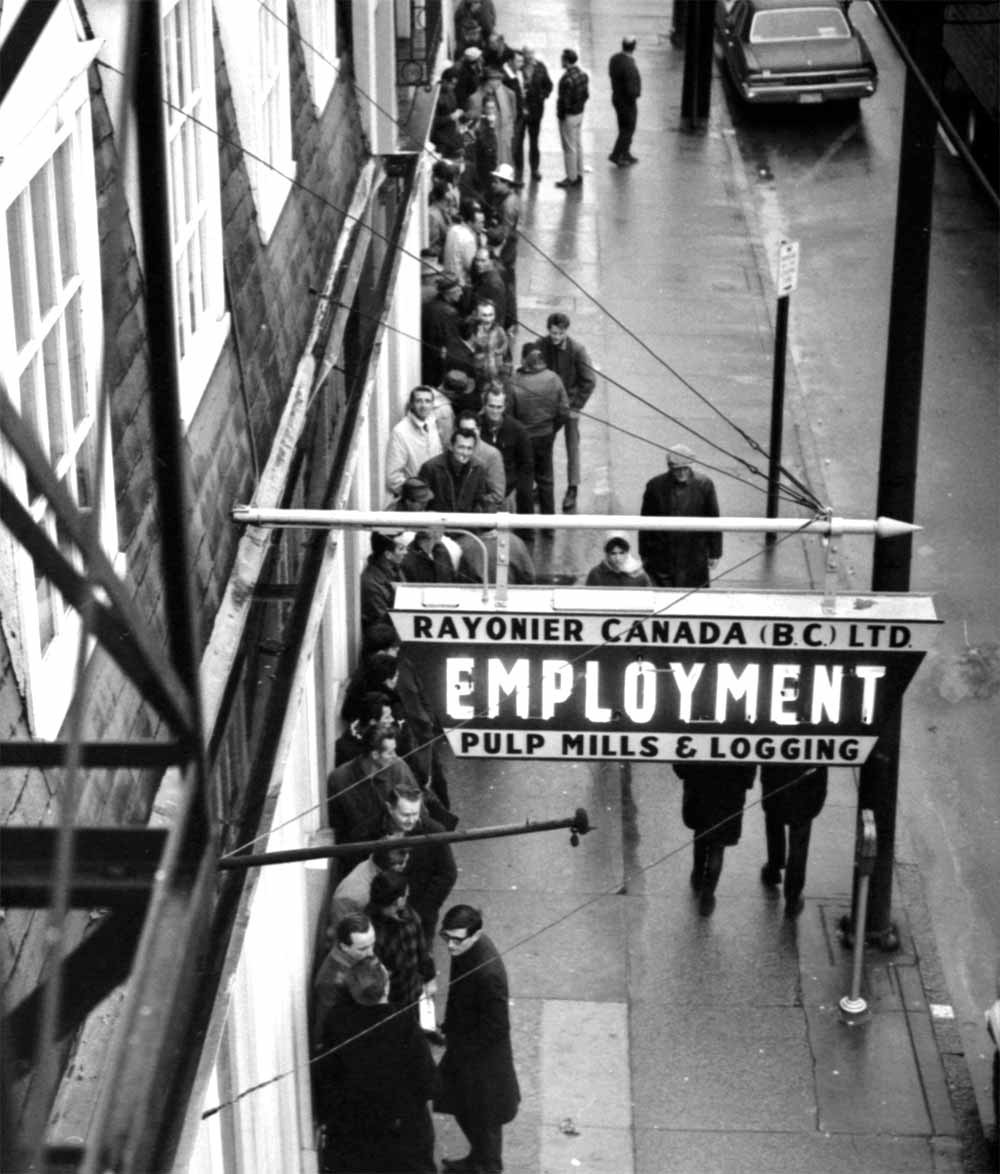 Workers line up outside of a Canadian employment office for pulp mills and logging