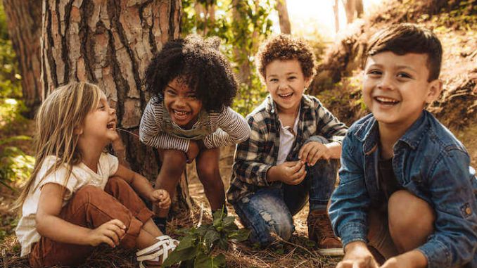 children-laughing-in-woods-compressed